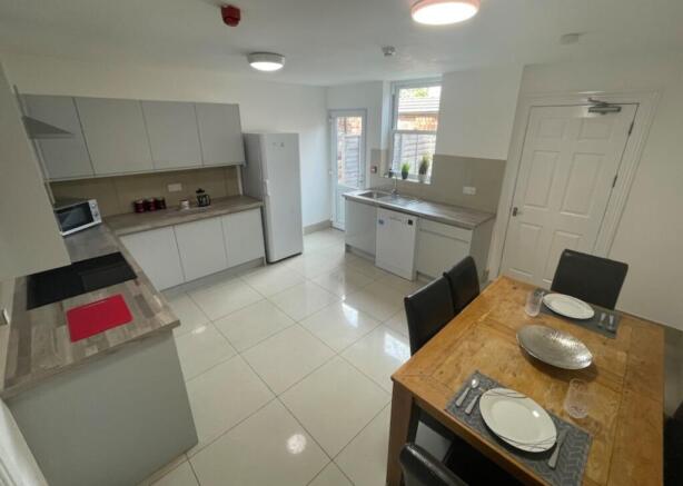 A spacious and modern kitchen with ample natura...