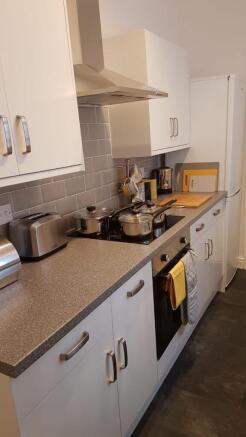 Bright modern kitchen with sleek white cabinets...