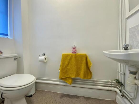 Bright bathroom with neat fixtures and towel ra...