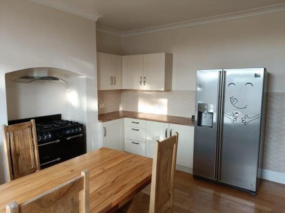 Bright and welcoming kitchen featuring modern w...