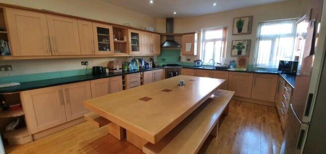 Spacious kitchen with large central dining isla...