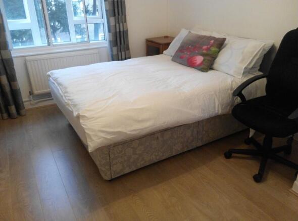 Bright bedroom with double bed and large window...