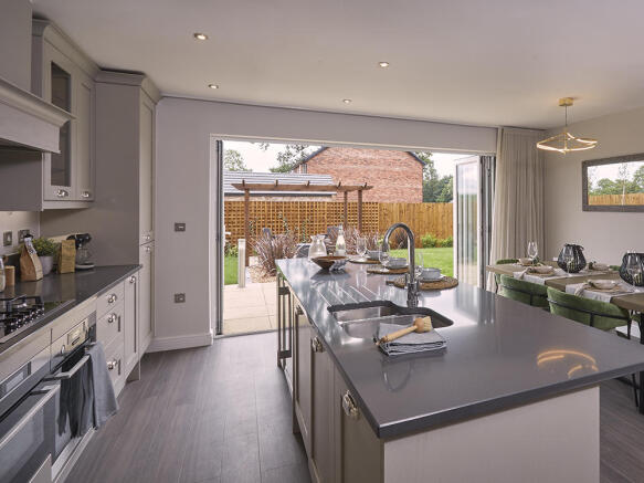 Bi-fold doors leading from the kitchen to the paved patio 
