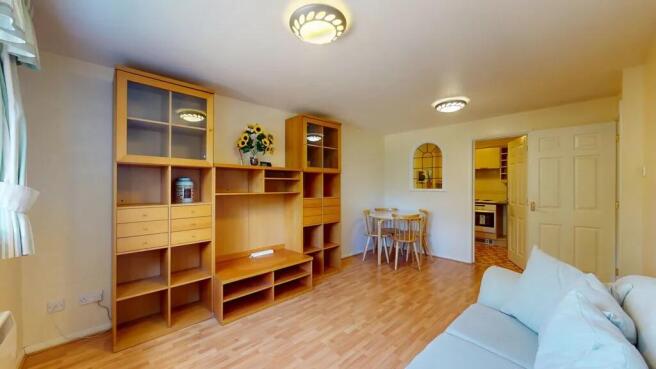 Bright, well-presented living room with warm wo...