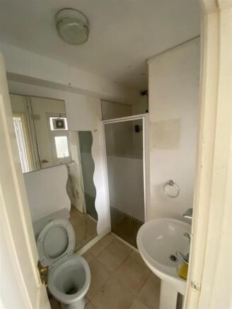 Practical shower room with classic white suite...