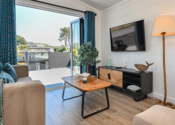 Bright Lounge With Bi Fold Doors And Coastal Style