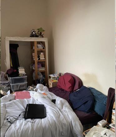 Cozy bedroom with a comfortable bed, soft beddi...