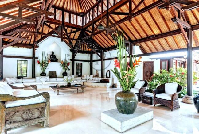 Spacious, open-air living room with wooden beams, 