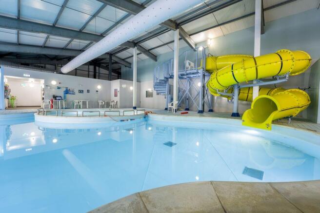 Indoor swimming pool with yellow flume slide at Bi