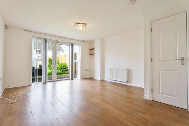 Spacious Lounge With View to Rear Garden Via French Doors