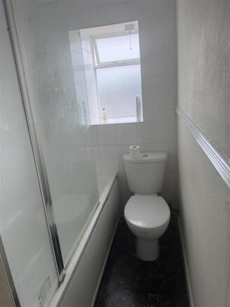 Bathroom with fitted bathtub and bright window...