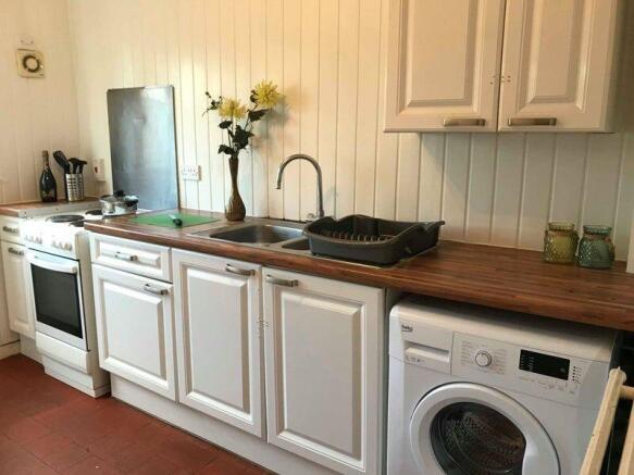 A clean, well-maintained kitchen featuring whit...