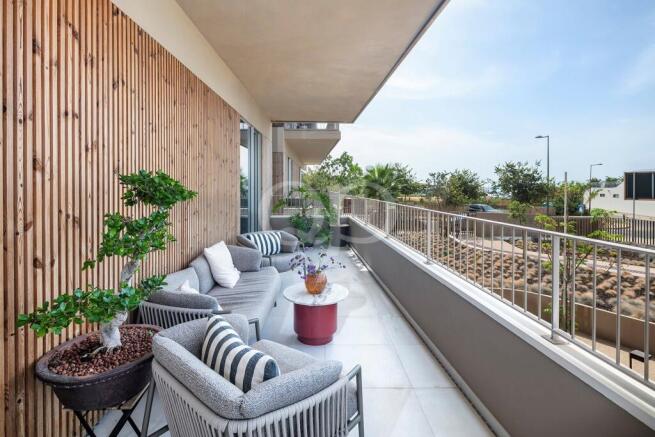 Spacious private balcony with comfortable seating and outdoor living area
