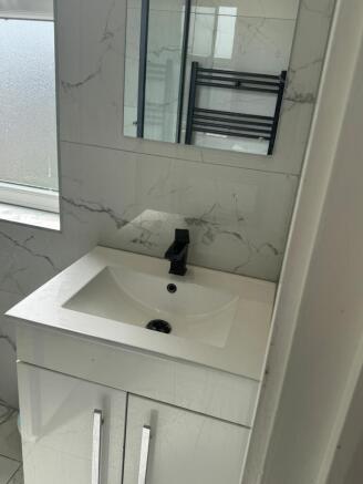 Sleek marble tiling and modern vanity unit...