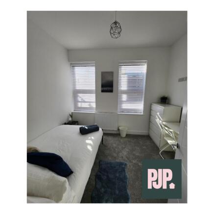 A bright and spacious double bedroom with moder...