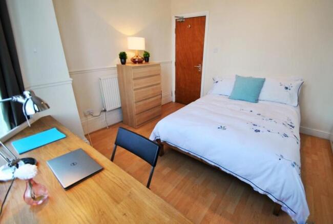 Bright spacious bedroom with a dedicated desk...