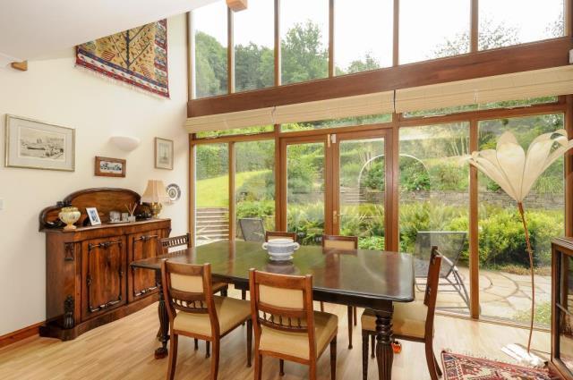 Dining room with full height glazing and gallery