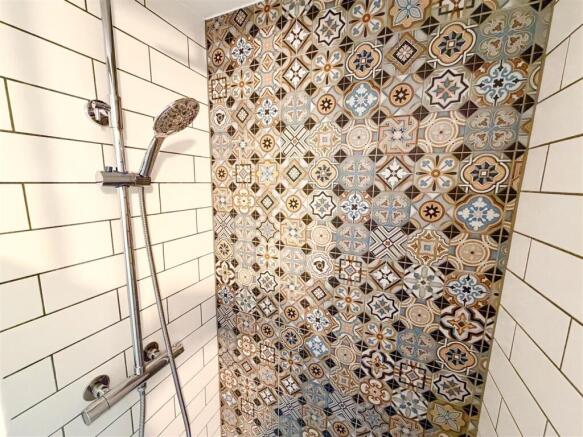 Stylish shower with vibrant patterned tiling...