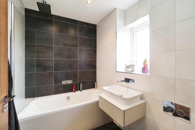 Contemporary main bathroom with floor to ceiling tiles and rain shower
