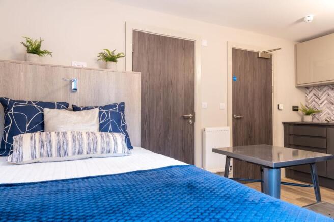 A modern single bedroom featuring a comfortable...