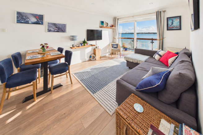 Sunlit Coastal Living Room with Sea View.png