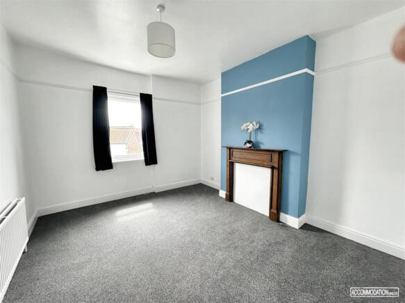 Bright bedroom with stylish blue feature wall...