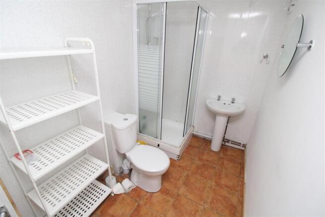 Bright bathroom with shower and storage shelvin...