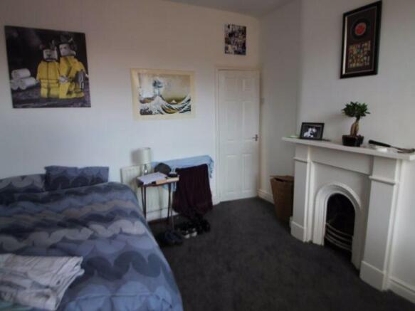 A cozy bedroom featuring a double bed with a bl...