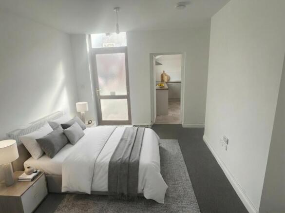 Bright, modern bedroom with large double bed...