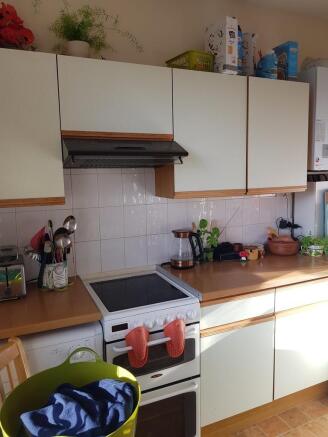 Bright fitted kitchen with light wood worktops,...