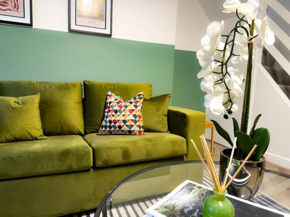 Stylish living area with vibrant green sofa...