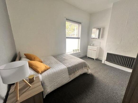 A bright and neatly arranged double bedroom fea...