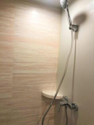 A clean and modern bathroom shower area featuri...