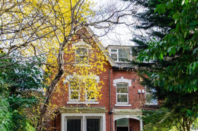 Charming brick house framed by vibrant greenery...