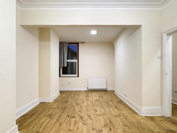 Bright, freshly painted rectangular bedroom wit...