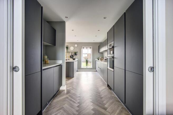 A modern kitchen area with ample storage