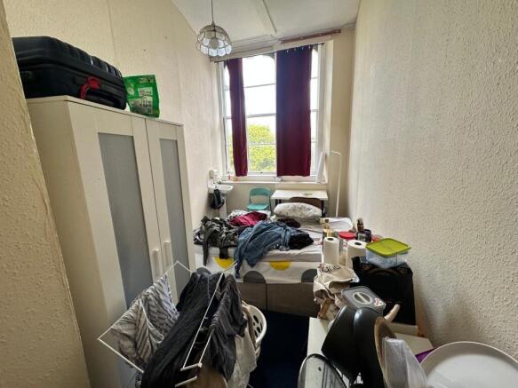 A cozy double bedroom with ample natural light ...