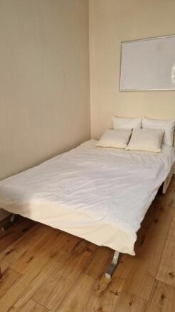 Bright bedroom with stylish wooden flooring...