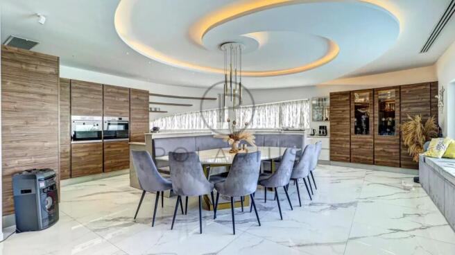 Modern kitchen with a large circular dining table,