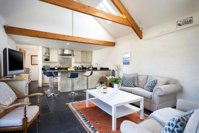 The open plan kitchen living space has vaulted ce