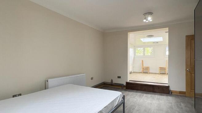 Spacious bedroom with bright adjoining sunroom ...