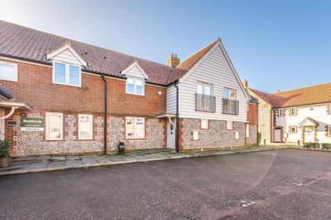 Modern Brick and Flint Residence with Upside-Down Layout