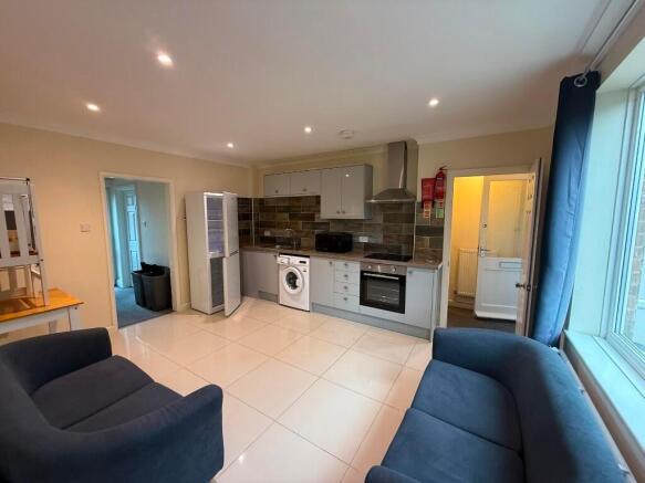 Bright open-plan living room with a modern fitt...