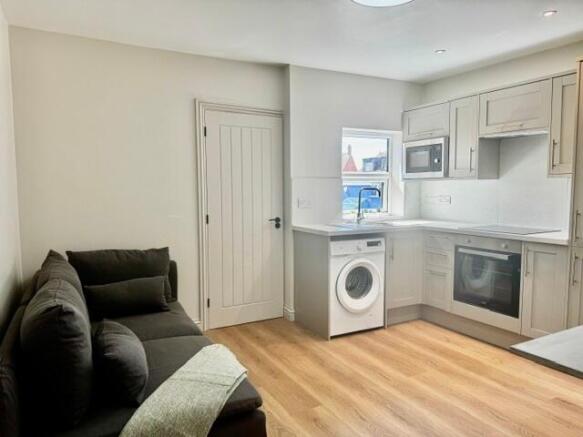Modern kitchen with chic cabinets and cozy sofa...
