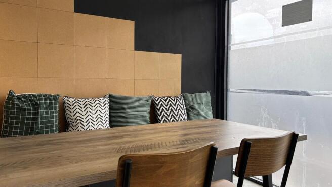 Stylish workspace with large table and cushions...