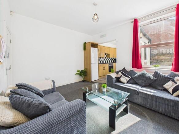 Bright, neatly presented living room with large...