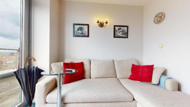 Bright cozy seating area with balcony access...