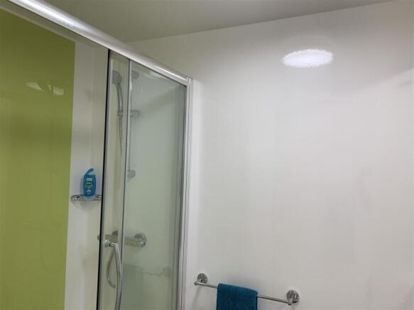 Modern shower cubicle with sleek lime accents...