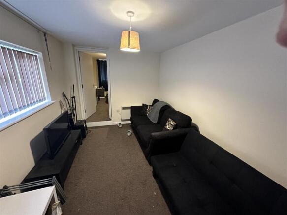 Cozy furnished living room with TV and sofa...