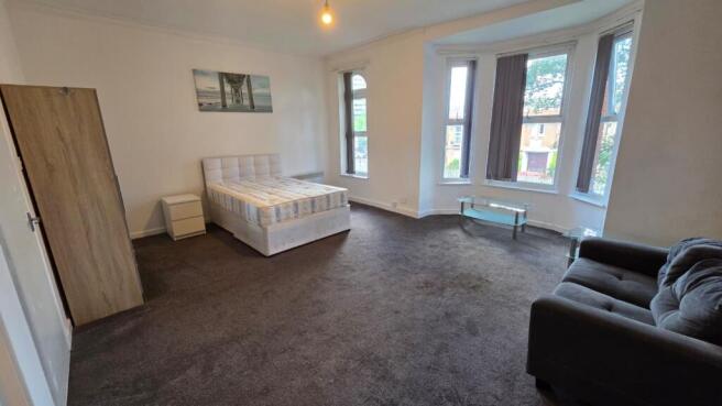 Spacious, bright bedroom with a double bed, lar...
